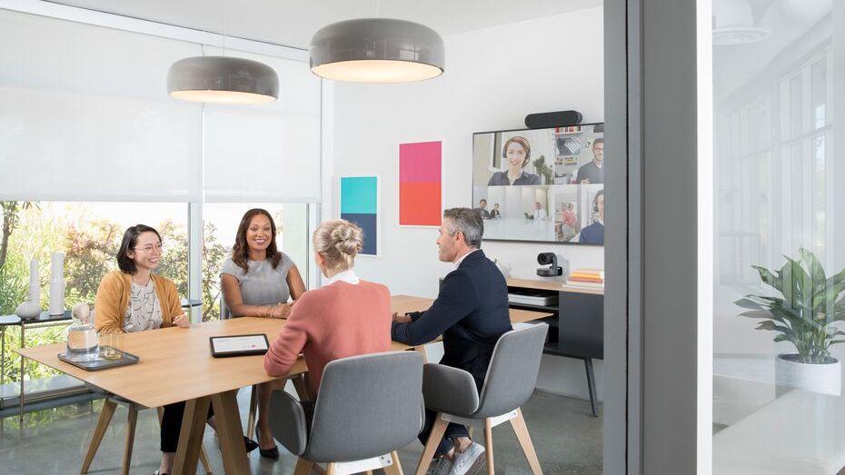 People in a conference room video conferencing with video conferencing equipments
