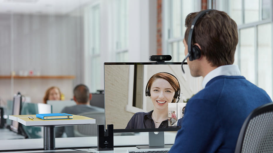 Man video conferencing at personal desk