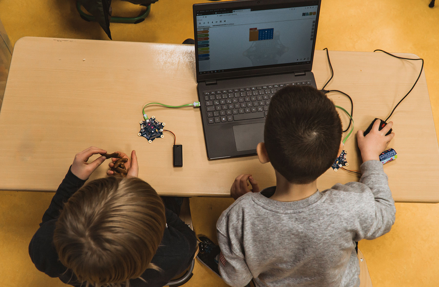 Children using laptop with a mouse connected